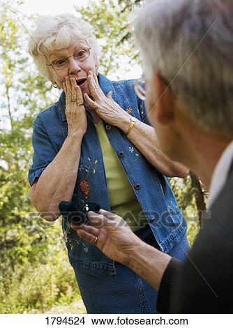 Picture - Man proposing to woman. Fotosearch