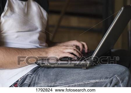 Picture - Man using a laptop. Fotosearch