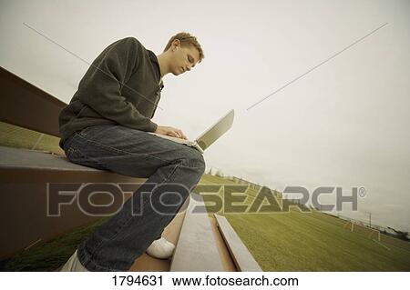 Stock Image - Man with laptop computer. Fotosearch