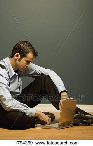 Man working on a laptop View Large Photo Image Stock Photo - Man working on a laptop. Fotosearch