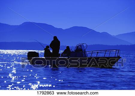 Stock Image - Men fishing in evening. Fotosearch