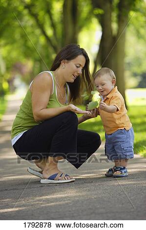 Mother and child look at leaf View Large Photo Image Stock Photo - Mother and child look at leaf. Fotosearch