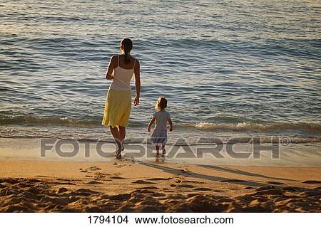 Picture - Mother and daughter at the beach. Fotosearch