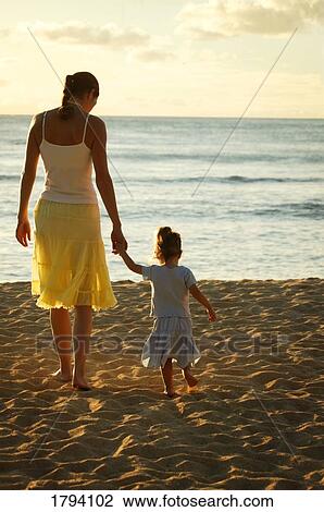 Mother and daughter at the beach View Large Photo Image Stock Image - Mother and daughter at the beach. Fotosearch