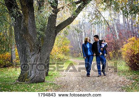 Parents with baby taking a walk View Large Photo Image Stock Image - Parents with baby taking a walk. Fotosearch