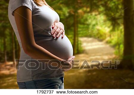 Pregnant woman on path View Large Photo Image Stock Photo - Pregnant woman on path. Fotosearch