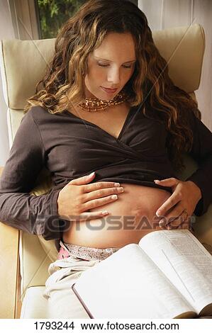 Pregnant woman reading the Bible View Large Photo Image Picture - Pregnant woman reading the Bible. Fotosearch