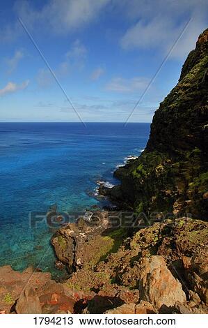 Stock Image - Rocky cliffs and ocean. Fotosearch