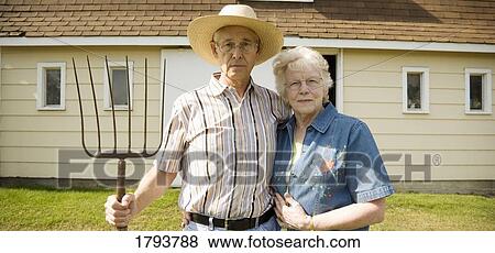 Stock Photo - Senior couple as American gothic. Fotosearch
