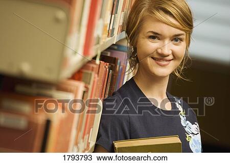 Student in a library View Large Photo Image Stock Image - Student in a library. Fotosearch