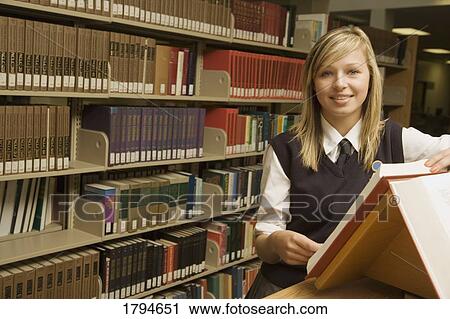 Student in a library View Large Photo Image Stock Image - Student in a library. Fotosearch