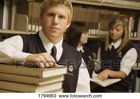 Student in a library View Large Photo Image Stock Image - Student in a library. Fotosearch