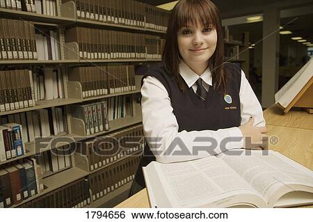 Student in the library View Large Photo Image Stock Photograph - Student in the library. Fotosearch