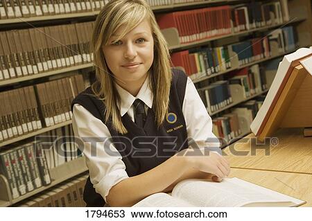 Stock Image - Student working in the library. Fotosearch