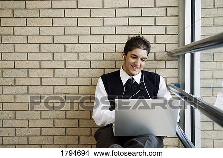 Picture - Student working on a laptop. Fotosearch