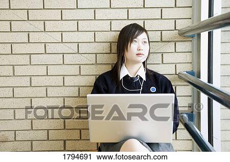 Student working on a laptop View Large Photo Image Stock Image - Student working on a laptop. Fotosearch