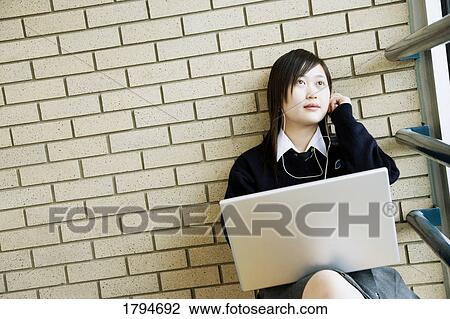 Stock Image - Student working on a laptop. Fotosearch