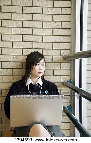 Stock Image - Student working on a laptop. Fotosearch