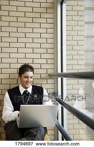 Stock Photo - Student working on a laptop. Fotosearch