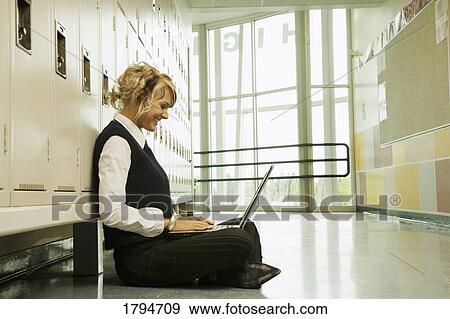 Student working on a laptop View Large Photo Image Stock Photo - Student working on a laptop. Fotosearch