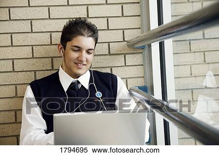 Student working on a laptop View Large Photo Image Stock Photography - Student working on a laptop. Fotosearch