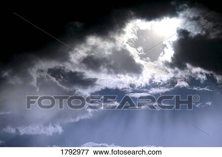 Sun shining through cloudy sky View Large Photo Image Stock Photo - Sun shining through cloudy sky. Fotosearch