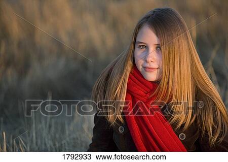 Teenage girl wearing a red scarf View Large Photo Image Stock Image - Teenage girl wearing a red scarf. Fotosearch