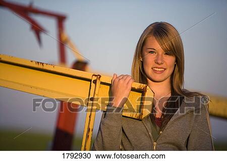 Teenage girl with farm machinery View Large Photo Image Stock Image - Teenage girl with farm machinery. Fotosearch