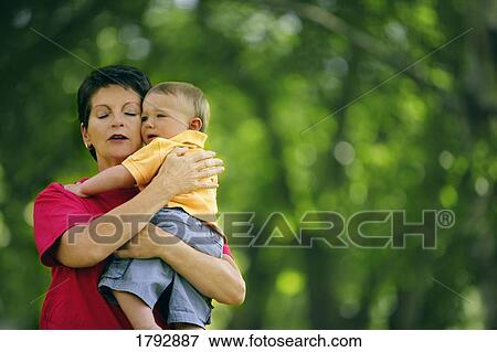 Stock Photo - Toddler is comforted while crying. Fotosearch