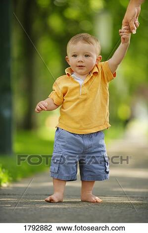Toddler walking down sidewalk View Large Photo Image Stock Image - Toddler walking down sidewalk . Fotosearch