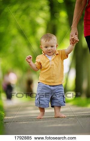 Toddler walking down sidewalk View Large Photo Image Stock Photography - Toddler walking down sidewalk . Fotosearch