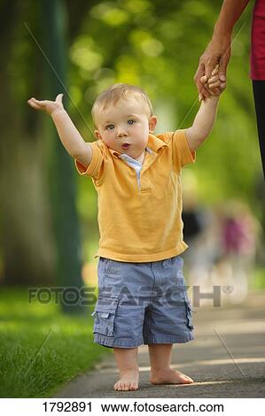 Toddler walking down the sidewalk View Large Photo Image Stock Image - Toddler walking down the sidewalk . Fotosearch