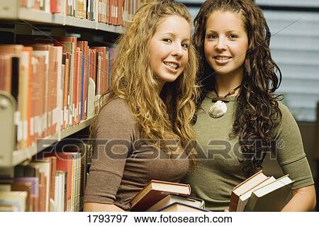Stock Photo - Twin students in a library. Fotosearch
