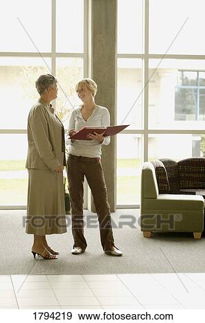 Two women talking View Large Photo Image Stock Photo - Two women talking. Fotosearch