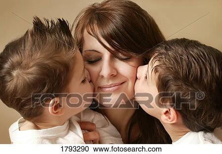 Stock Image - Two young boys kissing their mom. Fotosearch