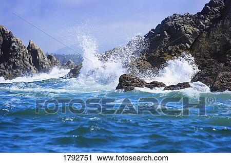 Stock Image - Waves crashing on rocks. Fotosearch