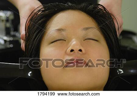 Woman having her hair washed View Large Photo Image Stock Photo - Woman having her hair washed. Fotosearch
