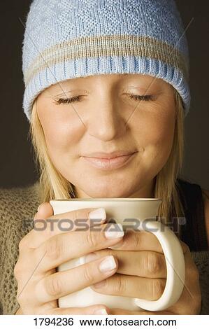 Stock Photograph - Woman holding a mug. Fotosearch