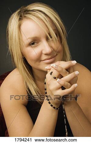 Woman holding Rosary beads View Large Photo Image Stock Image - Woman holding Rosary beads. Fotosearch