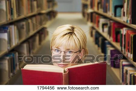 Woman in the library View Large Photo Image Stock Photograph - Woman in the library. Fotosearch