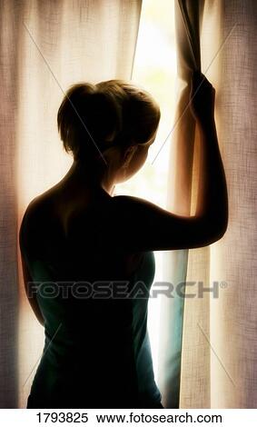 Woman looking out the window View Large Photo Image Stock Photography - Woman looking out the window. Fotosearch