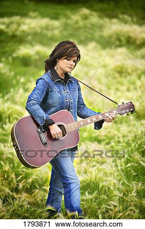 Stock Image - Woman playing guitar. Fotosearch