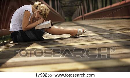 Stock Photography - Woman praying on a bridge. Fotosearch