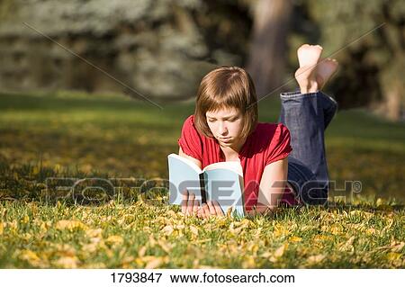 Woman reading a book View Large Photo Image Stock Photo - Woman reading a book. Fotosearch