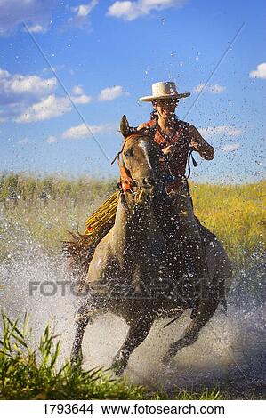 Picture - Woman riding a horse. Fotosearch