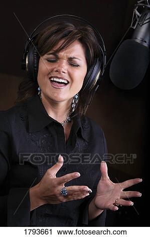 Woman singing in recording studio View Large Photo Image Stock Image - Woman singing in recording studio. Fotosearch