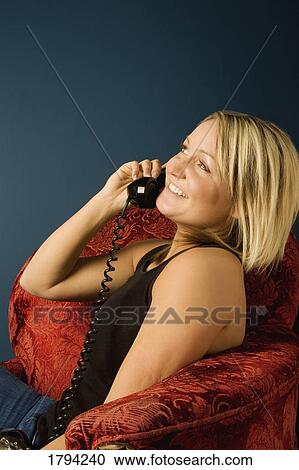 Woman talking on the telephone View Large Photo Image Stock Image - Woman talking on the telephone. Fotosearch