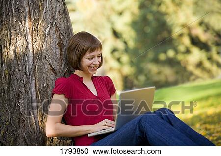 Stock Image - Woman typing on laptop. Fotosearch
