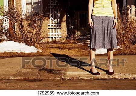 Woman waiting on the curb View Large Photo Image Stock Photo - Woman waiting on the curb. Fotosearch