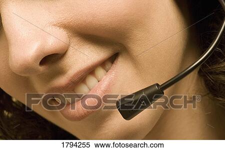 Stock Photography - Woman wearing a headset. Fotosearch